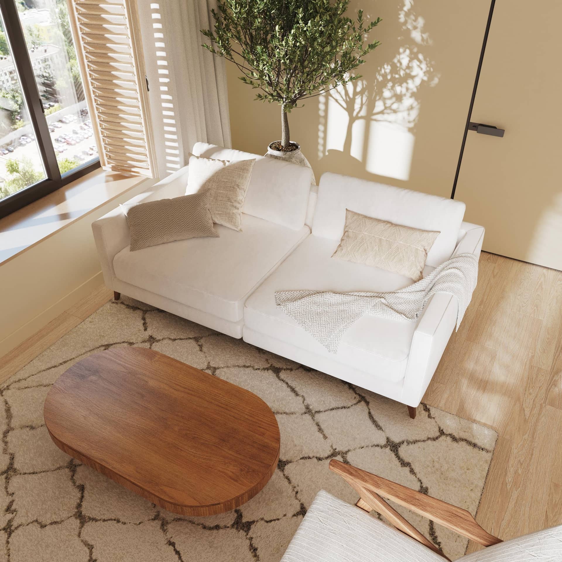 Зона отдыха - широкий белый диван и массивный деревянный журнальный стол